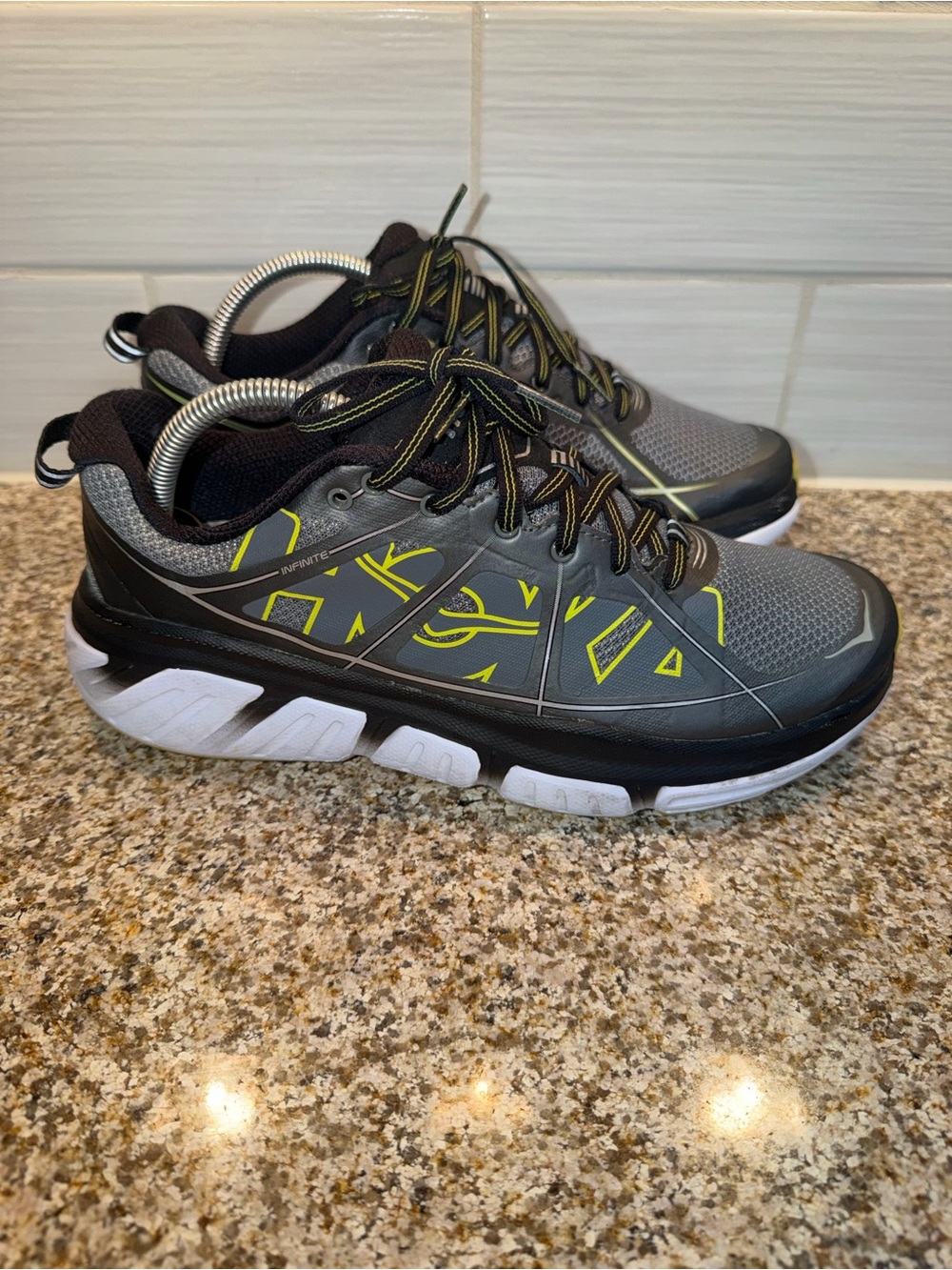 Hoka black shoe with pink insole strip